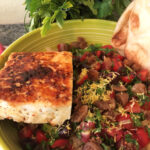 flatbread over a bed of couscous and vegetables